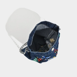 Blue denim crossbody bag with 3D floral and butterfly embroidery and silver chain strap