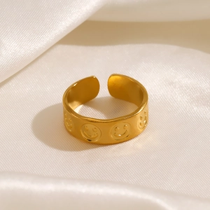 Adjustable gold plated titanium steel ring with embossed smiley faces on white silk