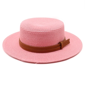 Pink flat top boater straw hat with brown faux leather belt buckle trim for summer travel