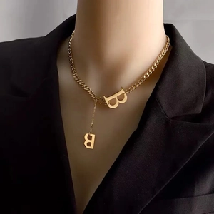 Hip hop Cuban chain necklace with letter B pendants worn by a model in black blazer