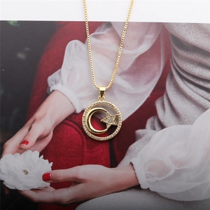 Detailed view of a gold circular necklace featuring a crescent moon and star zircon pendant
