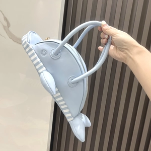 Detail of light blue dolphin-shaped PU leather handbag with white stripes and zipper