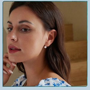 Close-up of elegant S925 sterling silver six-prong cubic zirconia hoop earring on ear