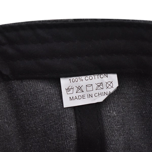 Detail view of the 100% cotton wash label and inner stitching on the baseball cap