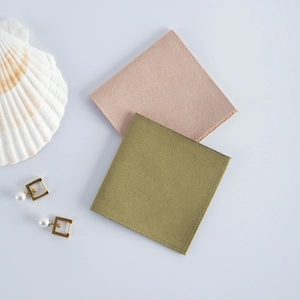 Macro shot of olive green and beige velvet jewelry pouches with decorative shells