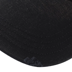Detail of black cotton baseball cap brim with multi-row stitching and frayed edges