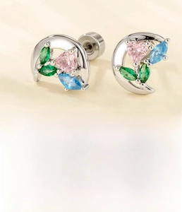 Macro view of moon-shaped earrings with pink heart zircon and titanium steel screw flat back