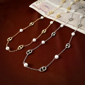 Close-up of gold and silver plated pig nose chain links with elegant white pearls