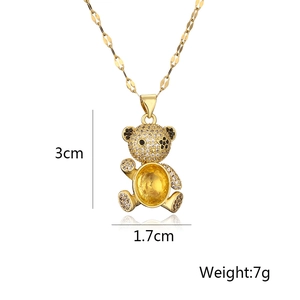 Detail view of a gold teddy bear pendant with yellow stones showing 3cm height dimensions
