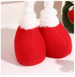 Macro detail of red velvet Christmas boots with white faux fur trim on a white surface