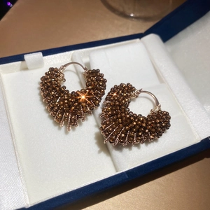 Close-up of vintage heart-shaped crystal beaded earrings in a premium jewelry gift box