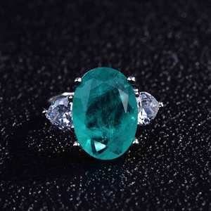 Macro view of pear-shaped Paraiba tourmaline stone with micro-pave diamond setting