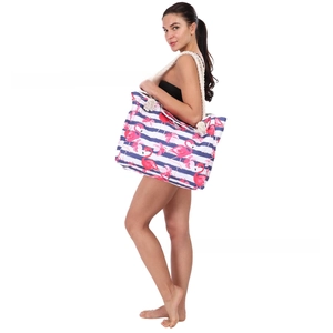 Detail of flamingo print beach bag with thick white rope handles for summer vacation
