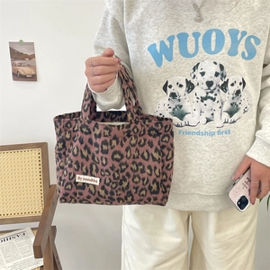 Detail of vintage leopard print tote bag in soft faux fur with stitched brand label