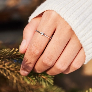 Elegant S925 sterling silver minimalist heart zircon ring worn near pine branches