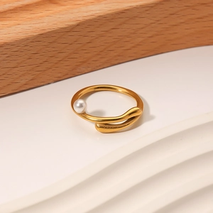 Irregular 18k gold plated stainless steel ring with freshwater pearl on a minimal wooden base