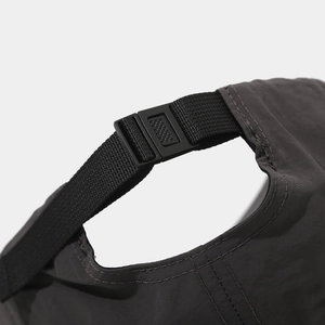 Close-up of adjustable strap and buckle on charcoal quick-dry sports baseball cap