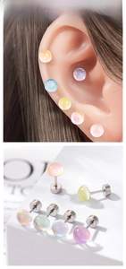 Detailed view of iridescent moonstone-style stud earrings in various pastel colors