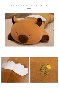 Detail of plush capybara with white angel wings and green lucky character embroidery