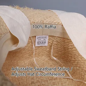 Internal detail of raffia sun hat showing 100% natural fiber label and size adjuster