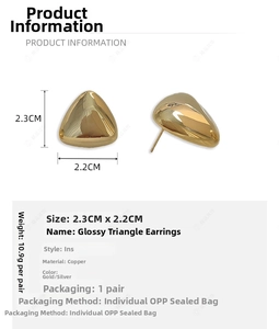 Detail view of gold triangle earrings showing 2.3cm by 2.2cm dimensions and copper material