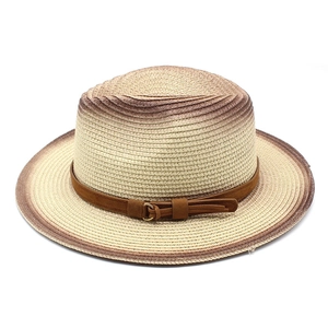 Detail view of woven straw hat featuring gradient beige finish and brown suede belt buckle