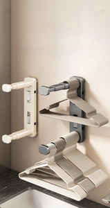 Close-up of telescopic clothes hanger rack with suction cup wall-mounted installation