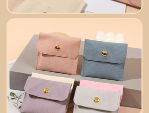 Macro detail of microfiber jewelry pouches with gold snap buttons in pastel colors