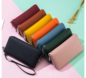Top view of eight color options for leather zip wallets with lychee pattern texture