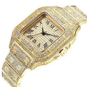 Detail of a gold square quartz watch with full rhinestone inlay and Roman numerals