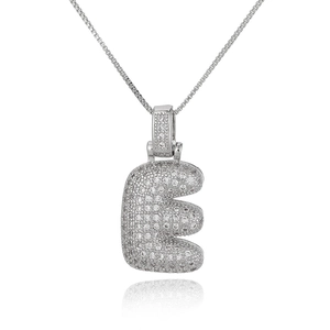 Macro detail of bubble style silver letter E pendant necklace with micro-pave zircons