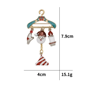 Detailed view of a Christmas hanger brooch with Santa and charms showing 7.9cm height