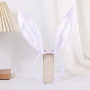 Detail of white satin bunny ears headband on a minimalist stand in a cozy setting