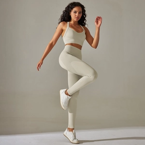 Close-up of seamless knitted texture and racerback detail on oat-colored yoga set
