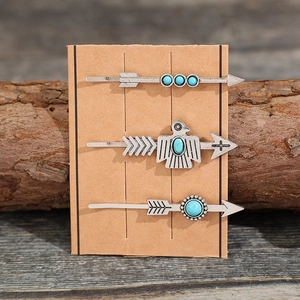 Set of 3 vintage silver arrow hair clips with turquoise beads on wood background