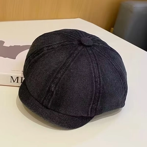 Close-up of the vintage denim newsboy cap showing detailed twill texture and stitching