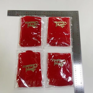 Detailed view of 4-piece red Christmas wine bottle covers with golden lettering and ruler