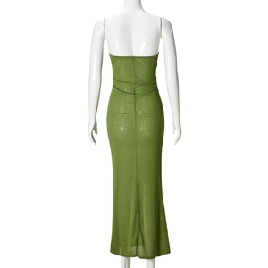 Detail of green back slit on a slim fit strapless dress with sheer knit texture