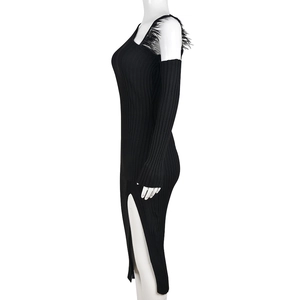 Detail of black knit dress featuring side slit and soft feather fringe decoration
