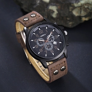 Detail shot of black Geneva watch with brown rivet leather strap on natural stone background