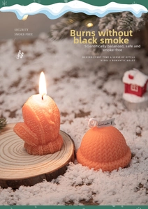 Detailed close-up of Christmas scented candles with orange knitted glove and hat textures