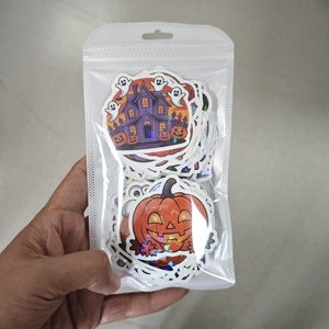 Detailed view of laser holographic Halloween stickers featuring pumpkin and ghost designs