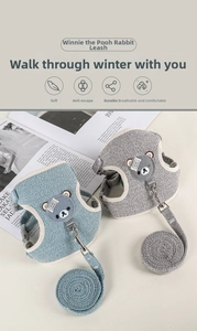 Detail of light blue and grey mesh pet harness with bear patch and durable metal buckle