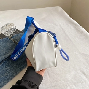 Minimalist blue and white cylinder canvas shoulder bag with branded wide strap