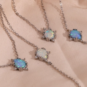 Stainless steel teardrop opal pendant necklace and bracelet set, elegant retro fashion jewelry.