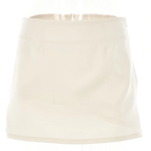 Detail view of a creamy white A-line mini skirt on a mannequin with high waist fit