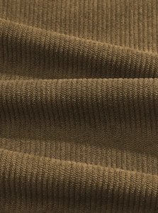 Detailed macro shot of dark brown corduroy fabric texture and ribbed knit structure