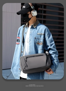 Side view of men's dark gray waterproof nylon messenger bag for city commute fashion