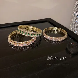 Elegant gold-plated bangle set with sparkling cubic zirconia in pink and green gems