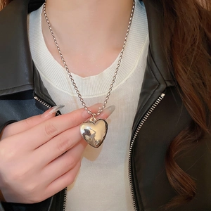 Chic silver heart pendant necklace with bead chain shown on a stylish model